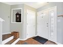 Inviting foyer with wood-look tile flooring, a decorative wall niche, and a front door with sidelights at 817 Claiborne Ln, Lebanon, IN 46052