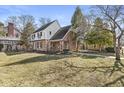 Side view of a charming home with brick and siding exterior, nestled in a landscaped yard at 83 W Garfield Ave, Martinsville, IN 46151