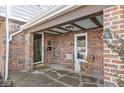 Charming front porch with stone floor and chairs at 83 W Garfield Ave, Martinsville, IN 46151
