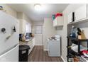 Cozy kitchen with white appliances, white cabinets, and plank flooring at 1142 Sharon Ave, Indianapolis, IN 46222