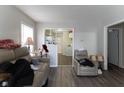 Bright living area featuring plank flooring, neutral walls, and an archway to the kitchen at 1142 Sharon Ave, Indianapolis, IN 46222