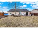 Large backyard with a patio area, green grass and a wooden fence, perfect for entertaining at 12689 Sovereign Ln, Fishers, IN 46038