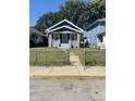 Traditional home with a well-maintained lawn and inviting front yard at 1310 N Lasalle St, Indianapolis, IN 46201
