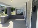 Inviting covered front porch with painted brick columns and secure front door at 1310 N Lasalle St, Indianapolis, IN 46201