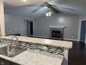 Open living space with fireplace, beam accent and modern finishes seen from kitchen at 1325 E 47Th St, Anderson, IN 46013