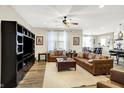 Spacious living room features a large entertainment center, comfortable seating, ceiling fan and natural light at 13553 Eastpark E Cir, Fishers, IN 46037