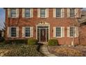 Detailed view of front entrance with decorative door and lush landscaping, accentuating home's inviting appeal at 14080 Old Mill Ct, Carmel, IN 46032