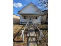 Traditional home exterior showcasing a covered porch and welcoming entrance, ideal for a Gathering at 1610 Central Ave, Anderson, IN 46016