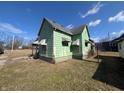 Side angled view of vintage home showing peeling paint and traditional design at 1628 Sherman St, Anderson, IN 46016