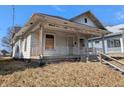 Exterior view of home featuring a cozy covered front porch at 1709 Central Ave, Anderson, IN 46016