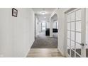 Bright hallway with hardwood flooring leading to a spacious living area and office at 2091 Creek Bank Dr, Columbus, IN 47201