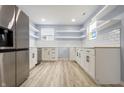 Bright kitchen with stainless steel appliances, white cabinets, and tile backsplash at 217 E Michigan St, Fortville, IN 46040