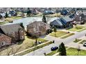 Residential area with well-kept houses, lawns, and street views, situated near a serene lake at 2267 Surface Dr, Greenwood, IN 46143