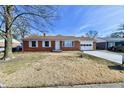 Charming brick ranch home featuring white trim, an attached garage and a well manicured front yard at 2521 Beechcrest Dr, Indianapolis, IN 46203