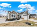 Charming single-story home with stone accents, a two-car garage, and a well-manicured lawn at 2691 Sand Hollow Dr, Lebanon, IN 46052