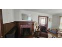 Living room featuring a decorative fireplace with mantel and brick surround at 341 N Bolton Ave, Indianapolis, IN 46219