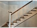 Classic staircase design with wooden handrail and white spindles at 341 N Bolton Ave, Indianapolis, IN 46219