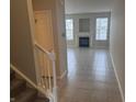 Inviting living room featuring tile flooring, a fireplace, and neutral paint tones at 4088 Weston Pointe Dr, Zionsville, IN 46077