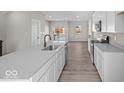 Bright, modern kitchen featuring white cabinetry, stainless steel appliances, and an island sink at 4150 Douro Trl, Westfield, IN 46062