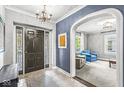 Elegant foyer featuring decorative tile flooring, an archway, and glimpses into the living space beyond at 4305 Central Ave, Indianapolis, IN 46205