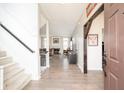 Spacious foyer showcasing hardwood floors and an open floor plan, seamlessly connecting living spaces at 4365 Weather Stone Xing, Zionsville, IN 46077