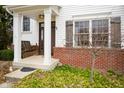 Inviting front porch with swing, classic brick accents, and decorative shutters offer a warm welcome at 4365 Weather Stone Xing, Zionsville, IN 46077