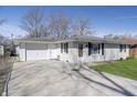 Charming single-story home with an attached garage and a well-manicured lawn at 4623 Clark St, Anderson, IN 46013