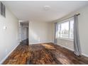 Sunlit living room boasts wood floors and neutral walls, enhanced by ample windows and natural light at 4623 Clark St, Anderson, IN 46013