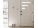 The bright white front door has privacy glass and modern hardware at 5210 Ashbourne Ln, Indianapolis, IN 46226