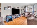 Comfortable living room with a large TV, hardwood floors, and cozy seating, creating a warm and inviting atmosphere at 606 Memorial Dr, Beech Grove, IN 46107