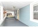 Cozy front porch featuring a charming porch swing and a bright yellow door at 6179 Norwaldo Ave, Indianapolis, IN 46220