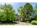 Inviting two-story home featuring manicured landscaping and a charming stone and brick facade at 6560 Dawson Lake Dr, Indianapolis, IN 46220