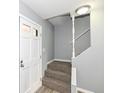 Inviting entryway with gray walls, carpeted stairs and white trim, offering a warm welcome at 7322 S Sherman Dr, Indianapolis, IN 46237