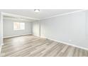Bright living room features sleek floors, neutral walls, and ample natural light through a large window at 7322 S Sherman Dr, Indianapolis, IN 46237
