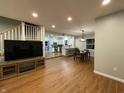 Spacious living room with wood floors that opens to a bright kitchen with stainless steel appliances at 8221 S 300 W, Muncie, IN 47302