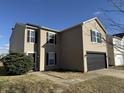 Attractive two-story home showcasing its front facade with black shutters, a two-car garage, and a tidy yard at 8360 S Evening Dr, Pendleton, IN 46064