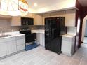 Modern kitchen features stainless steel appliances, gray backsplash, and gray cabinets at 8940 Black Hawk Ln, Indianapolis, IN 46234