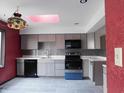 Bright kitchen features gray cabinets, subway tile backsplash, and modern appliances at 8940 Black Hawk Ln, Indianapolis, IN 46234