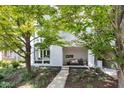 Modern townhome with a manicured front yard, featuring a gray brick facade and inviting covered porch at 932 N Broadway St # 1, Indianapolis, IN 46202