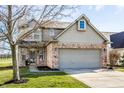 Charming two-story home featuring brick accents, attached two-car garage, and well-maintained landscaping at 9723 Innisbrook Blvd, Carmel, IN 46032