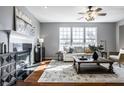 Elegant living room featuring a fireplace, hardwood floors, ample natural light, and stylish decor at 9723 Innisbrook Blvd, Carmel, IN 46032