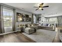 Open-concept living room offering hardwood floors, a plush sectional sofa and ample natural light at 10326 Haag Dr, Brownsburg, IN 46112