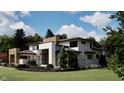 Back of modern home featuring natural wood accents and professionally landscaped grounds at 10440 Somerford Rdg, Zionsville, IN 46077