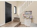 Warm entryway featuring wood floors, complemented by a staircase and decorative accents at 10540 Bartley Dr, Indianapolis, IN 46236