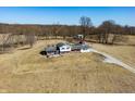 Expansive property featuring a charming home, long driveway, and mature trees amidst open land at 1125 S Buffalo Hill Rd, Martinsville, IN 46151