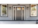 Elegant front door showcasing sidelights and a transom window, framed by modern light fixtures at 1234 S Talbott St, Indianapolis, IN 46225