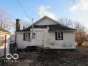 Rear exterior view of a house, highlighting its back door and window at 1310 E 5Th St, Muncie, IN 47302