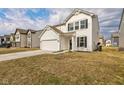 Attractive two-story home with white siding, a two-car garage, and a well-manicured lawn at 1381 Delacorte Cir, Shelbyville, IN 46176