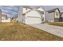 Side view of a two-story house with a two-car garage and well-kept lawn at 1381 Delacorte Cir, Shelbyville, IN 46176