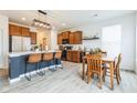 Modern kitchen features an island with seating, stainless steel appliances, and an adjacent dining area at 1381 Delacorte Cir, Shelbyville, IN 46176